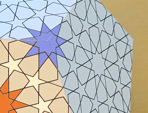 A closeup of a dodecahedron decorated with an Islamic design