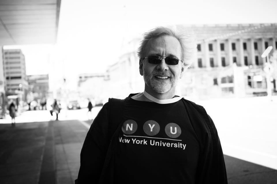 Ned outside with his hair blowing wildly